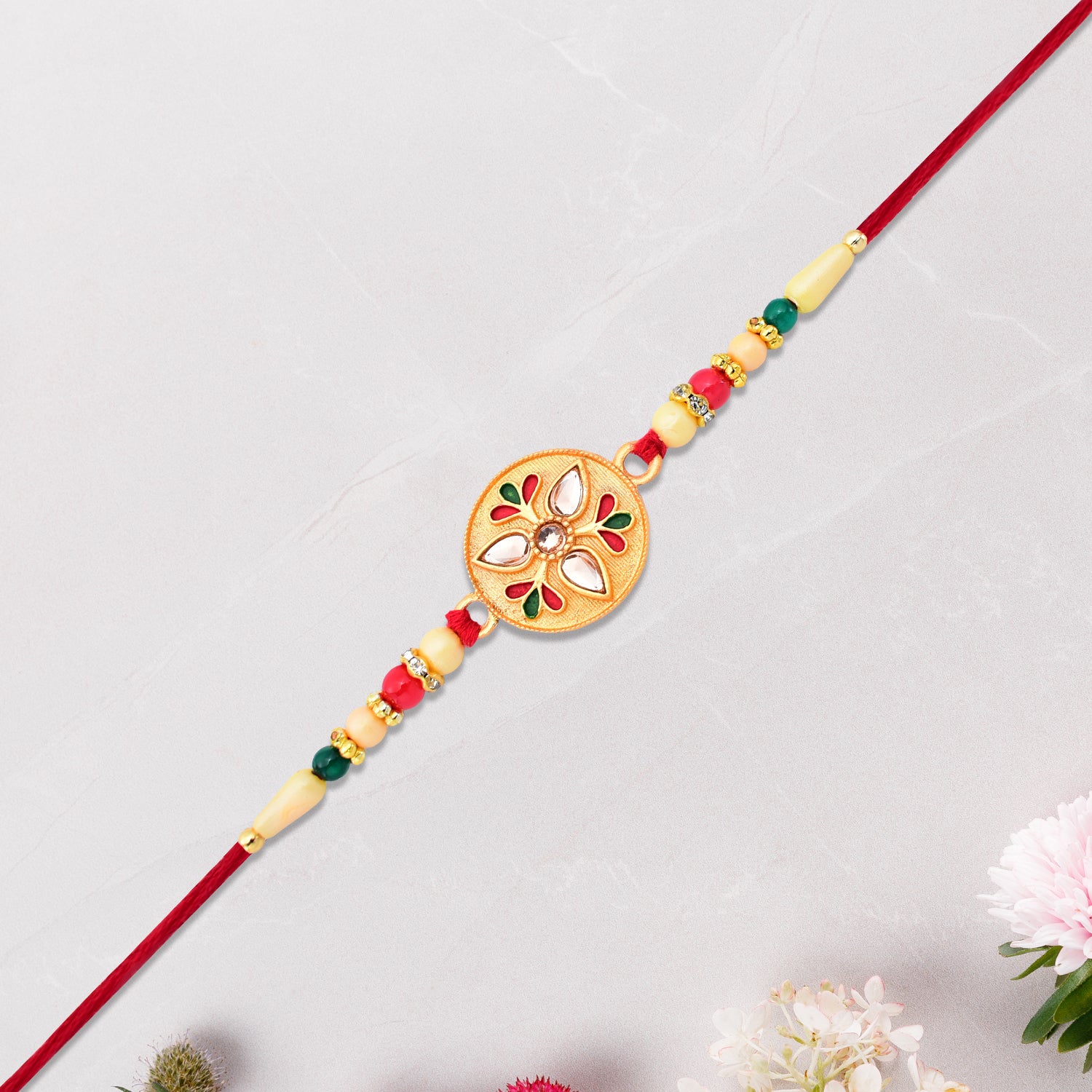 Sacred Kalash Design Rakhi With Embellished Beads And Red Thread Sacred Kalash Design Rakhi With Embellished Beads And Red Thread